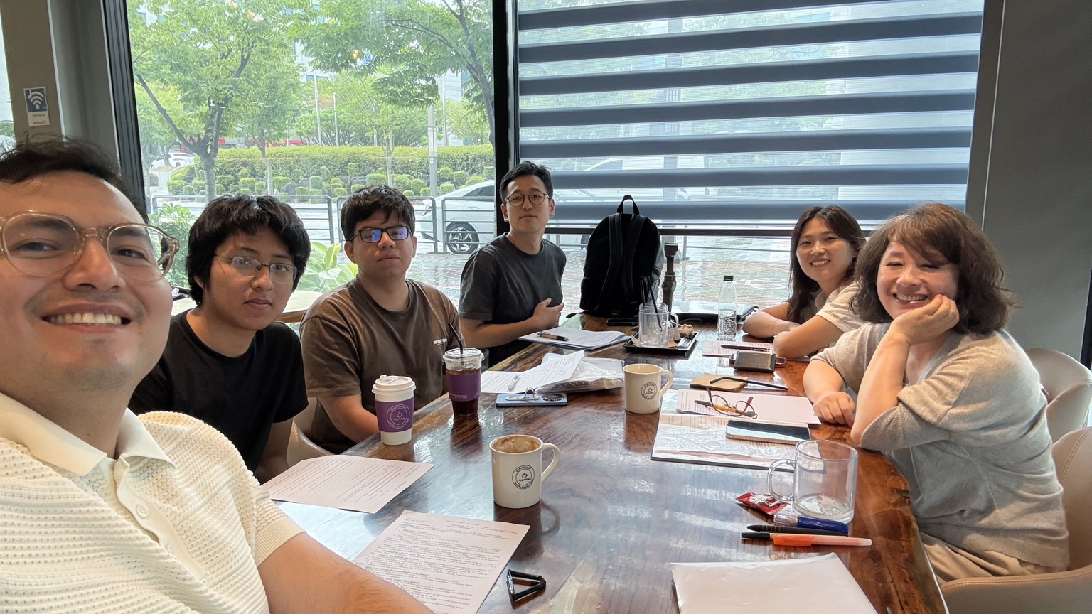Discipleship meeting around a table with Bible study materials