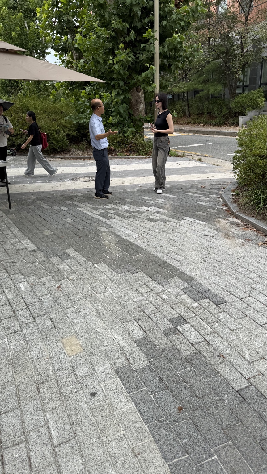 A believer sharing the gospel with a passerby on a Jeonju street